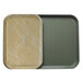 A tan Cambro tray insert with an abstract design on a plastic surface.