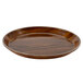 A Cambro round fiberglass tray with a brown Burma teak finish.