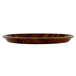 A Cambro round fiberglass tray with a Burma Teak wooden surface.