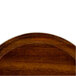 A Cambro round fiberglass tray with a Burma teak wood design.