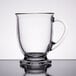 An Anchor Hocking clear glass cafe mug with a handle on a table.