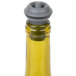 A Vacu Vin wine stopper with a grey lid and black band on a bottle.