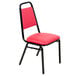 A Lancaster Table & Seating red banquet chair with black frame and red seat.