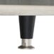 The metal legs of a TurboChef electric countertop conveyor oven with a black and silver base.