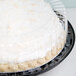 A D&W Fine Pack black plastic pie container with a clear high dome lid holding a pie with coconut on top.