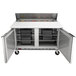 A Beverage-Air stainless steel refrigerated sandwich prep table with two doors and a cutting board lid.