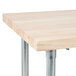 An Advance Tabco wood work table with a galvanized metal base.