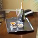 A Cambro hotel room service tray with food, champagne, and chocolate-covered desserts.