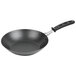 A close-up of a black Vollrath frying pan with a black handle.