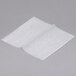 Durable Packaging interfolded white wax paper on a gray surface.
