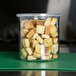 A Carlisle clear plastic crock filled with croutons.