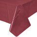 A white rectangular table with a burgundy Creative Converting plastic table cover.