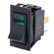A black rectangular on/off switch with green lights on it.