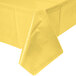 A Mimosa yellow plastic table cover on a table with a white background.
