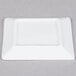 A 3" bright white square porcelain plate with a black border on a white surface.