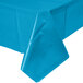 A turquoise blue plastic tablecloth from Creative Converting on a table.