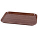 A rectangular brown Cambro fiberglass tray with a wood grain finish.