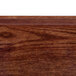 A close up of a Country Oak Cambro tray with a wood surface.