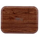 A rectangular Cambro Country Oak fiberglass tray with a wood surface.