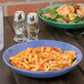 A bowl of pasta and salad in a Mardi Gras Diamond melamine bowl on a table.