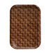 A brown Cambro basketweave tray insert with a pattern on a woven surface.
