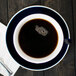 A CAC Venice blue cup of coffee on a saucer