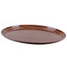 A brown oval Cambro fiberglass tray with a wood grain finish.