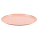 A dark peach oval Cambro tray with a round rim on a white background.