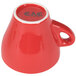 A red CAC Venice espresso cup with a saucer and a red surface.