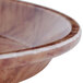 A Cambro round fiberglass tray with a dark brown basketweave design on the rim.