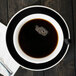 A CAC Venice black cup of coffee on a saucer