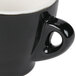 A close-up of a black CAC Venice espresso cup on a counter.