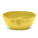 A yellow Elite Global Solutions melamine bowl on a white surface.