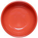 A close up of a red bowl with a white background.