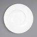 An Elite Global Solutions white melamine bowl with a spiral design on a white surface.