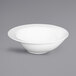 An Elite Global Solutions white melamine bowl with a round rim.
