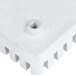 A white plastic square push block with a screw on the side.