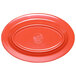 A red oval melamine platter with a white background.