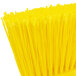 A close up of a Carlisle yellow broom head.