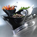 A black Elite Global Solutions small oval bowl with vegetables in it.