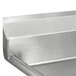 A stainless steel Advance Tabco one compartment sink with two drainboards on a metal surface.