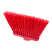 A red Carlisle broom head with long, unflagged bristles.