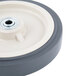 A gray Cambro Easy Wheel with a black rim and white center with a hole in it.