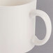 A close up of a Homer Laughlin ivory mug with a handle.