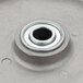 A metal Cambro wheel bearing with a round hole in it.