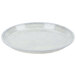A Cambro round white fiberglass tray with a speckled surface.