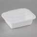 A Pactiv Newspring white rectangular microwavable container with lid.