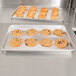 A Vollrath Wear-Ever bun pan with cookies cooling on a counter.