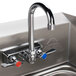 An Advance Tabco stainless steel hand sink with a splash guard and right side faucet.
