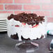 A clear Fineline trifle bowl filled with a chocolate and strawberry trifle with whipped cream.